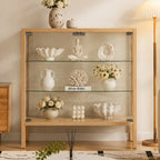 Front view of the light-framed glass display cabinet with three display levels and slim raised legs.