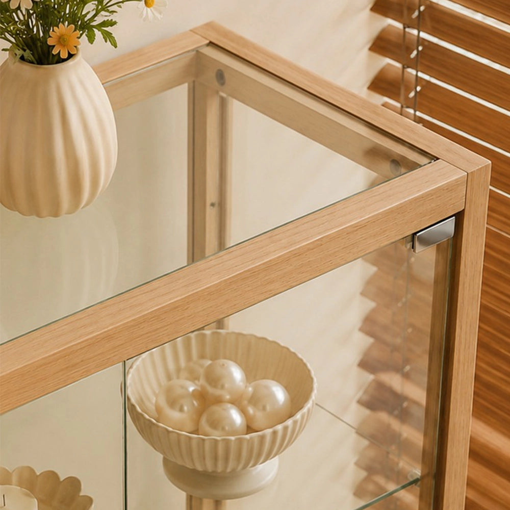 Overhead detail of the display cabinet's glass top and light wood-tone corner frame.