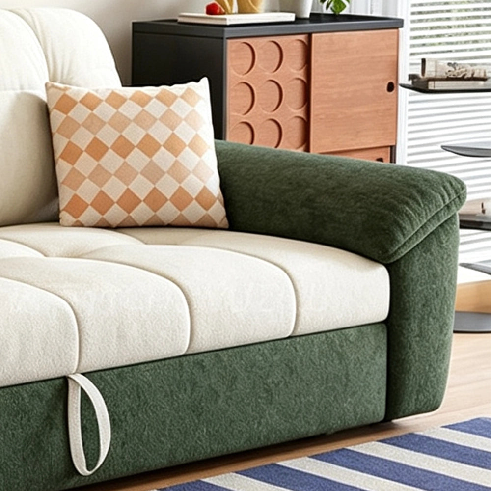 Close-up of the sofa bed's green arm, cream seat cushion and front pull loop.