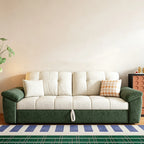 Green and cream sofa bed in sofa form with cream tufted cushions, dark green arms and a front pull loop.