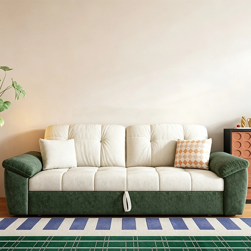 Green and cream sofa bed in sofa form with cream tufted cushions, dark green arms and a front pull loop.