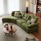 Overhead angled view of the green sectional sofa, tufted seat cushions and patterned pillows.
