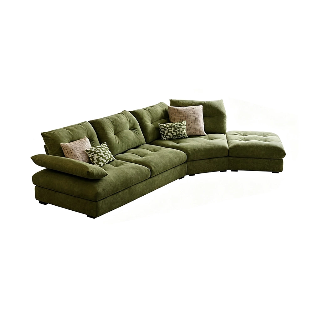 Green curved sectional sofa with tufted cushions and an extended seat on the right as pictured.