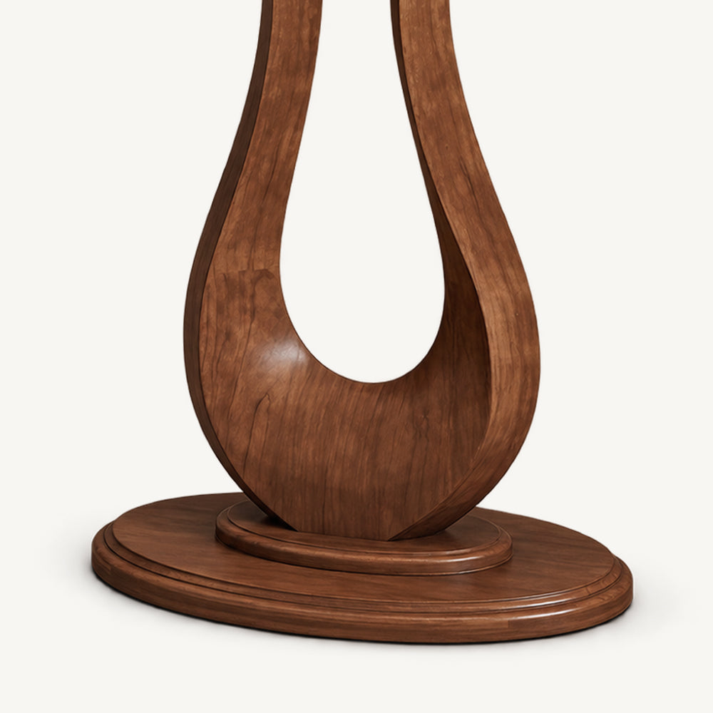 Close-up of the console table's curved pedestal resting on a layered oval foot.