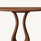 Detail of the console table's curved tabletop edge and upper pedestal.