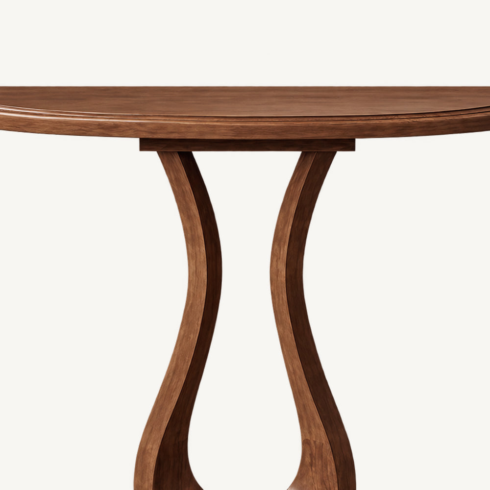 Detail of the console table's curved tabletop edge and upper pedestal.