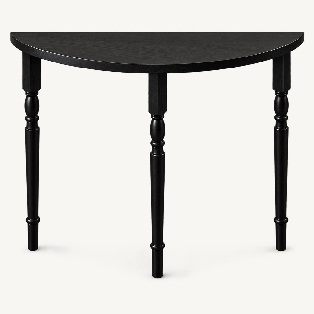 Front detail of the black console table's semicircular top and turned legs.