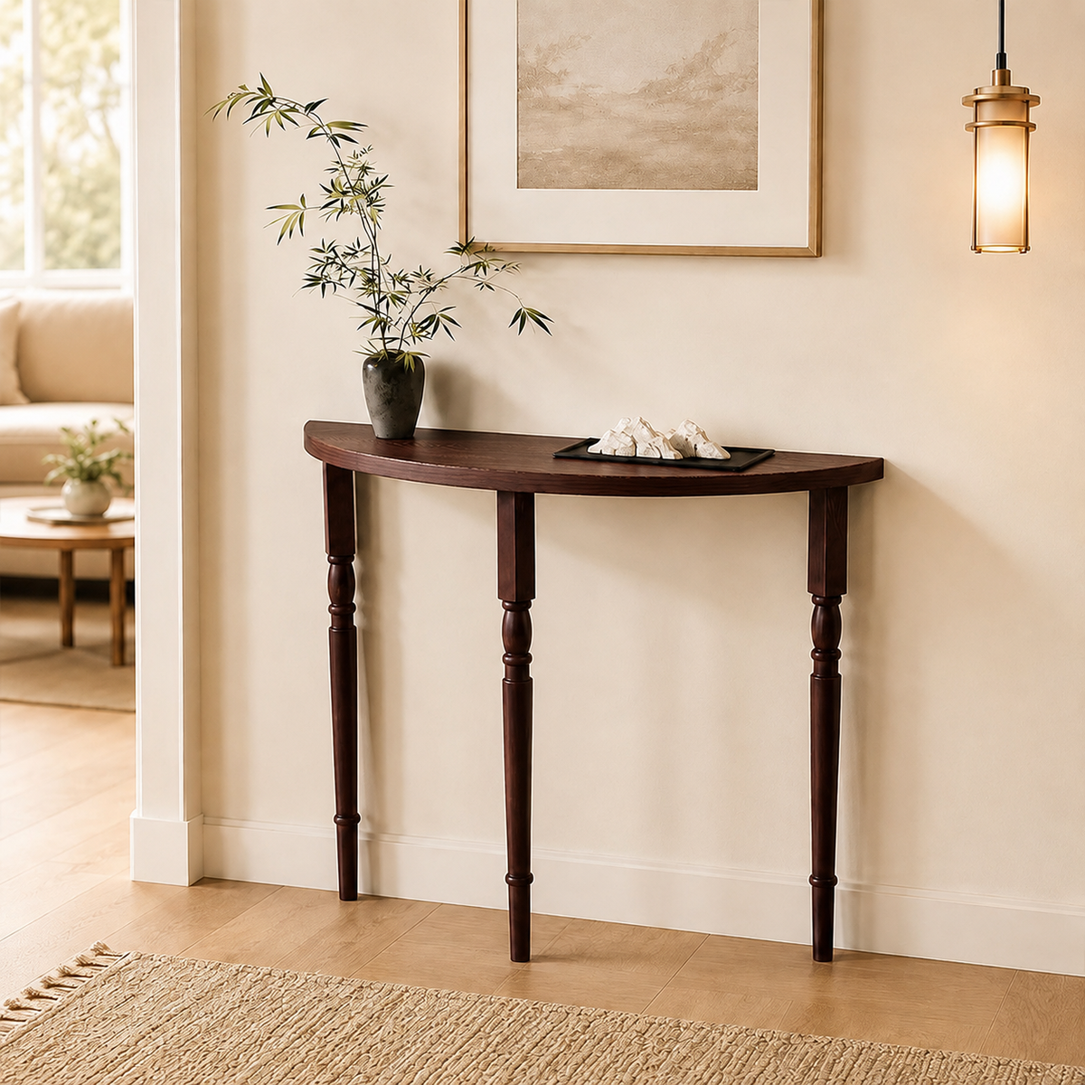 Brown half-moon console table with turned legs, styled beneath artwork in an entryway.