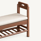 Close-up of the brown shoe bench's raised handhold arm, cream cushion and slatted rack.