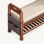 Close-up of the shoe bench's dark hanging side organizer with multiple pockets beneath a handhold arm.