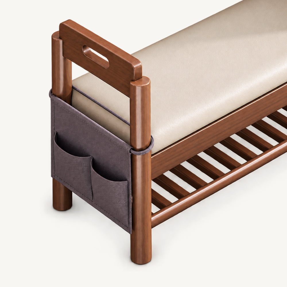 Close-up of the shoe bench's dark hanging side organizer with multiple pockets beneath a handhold arm.