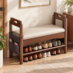Brown shoe bench with a cream cushion, raised handhold arms, lower shoe rack and hanging side organizer.