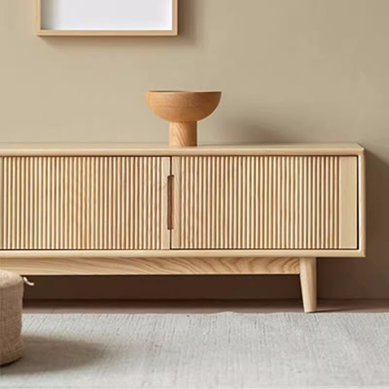 Front detail of the media console's vertical fluted doors and slim central handles.