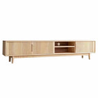 Light wood-tone media console with fluted storage fronts and open shelves including a circular cable opening.