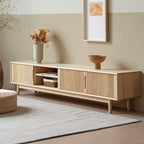 Angled view of the light media console showing fluted fronts, open media shelves and short legs.