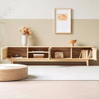 Light wood-tone media console with doors open to reveal shelves holding books, a basket and small objects.
