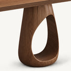 Close-up of the console table's rounded loop base and teardrop-shaped open center.