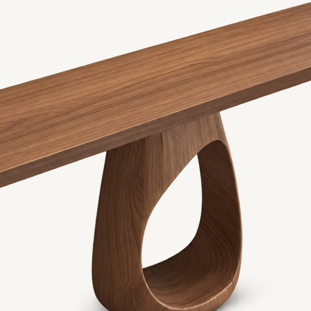 Close-up of the console table's wood-grain tabletop and the top of its loop-shaped pedestal.