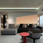 Front view of the low dark sofa with contrasting gray textured chaise and accent cushions.