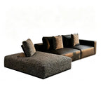Dark modular sofa with a gray textured chaise and contrasting loose back cushions.
