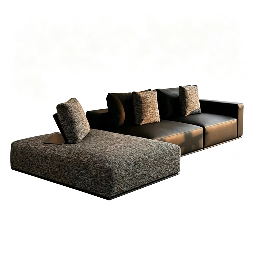 Dark modular sofa with a gray textured chaise and contrasting loose back cushions.