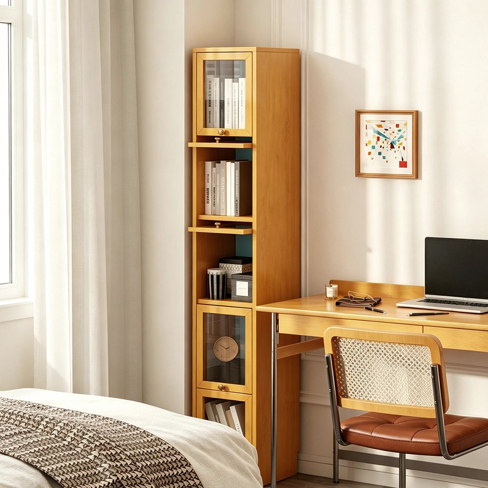Narrow honey-colored bookcase beside a desk, with books displayed in open and glass-front compartments.