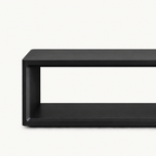 Close-up of the black bench's front frame corner and open shelf.