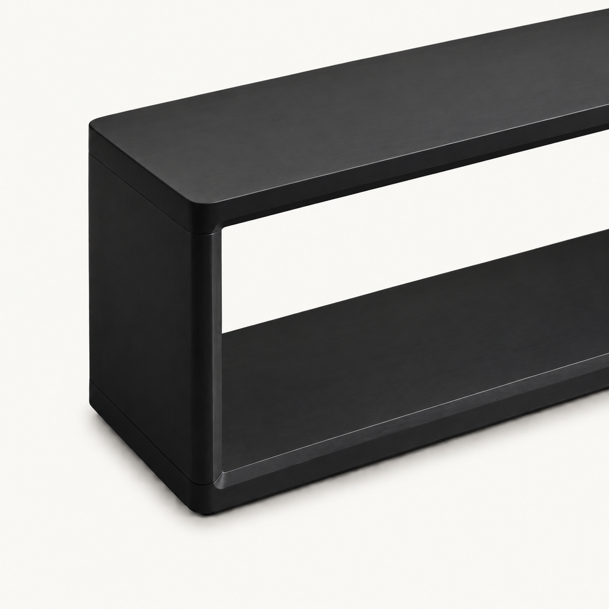 Detail of the black bench's outer side panel and rounded top corner.