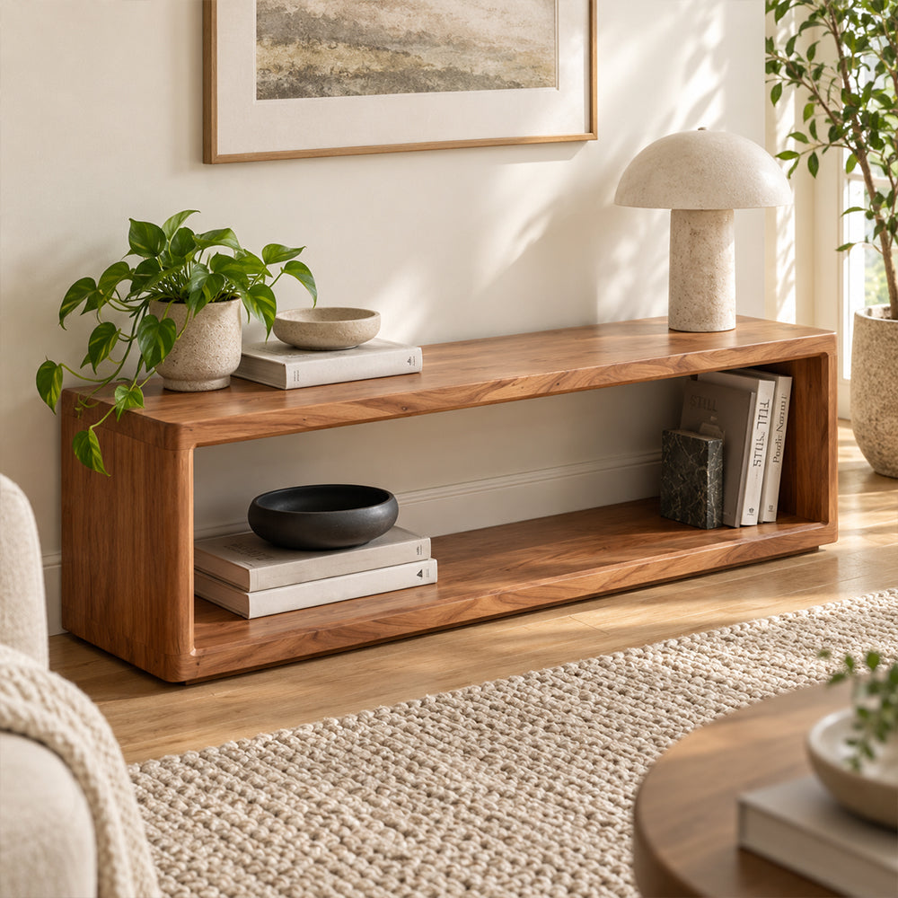 Brown open-frame bench with a long lower shelf, styled beside plants and a floor lamp.