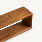 Overhead detail of the brown bench's long top and rounded end edges.