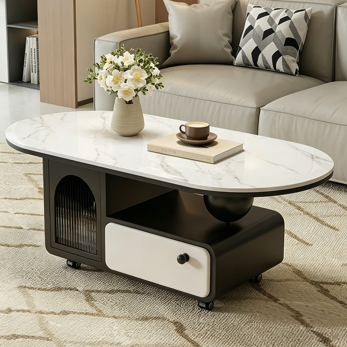 Oval coffee table with a pale veined top, dark storage base, cream drawer and arched glass cabinet.