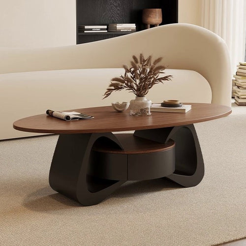 Oval brown-top coffee table with a dark curved base and central storage, beside a cream sofa.