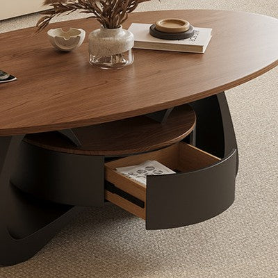 Close-up of the oval coffee table's open curved-front drawer with a magazine inside.