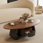 Angled view of the oval coffee table with its curved-front drawer pulled open.