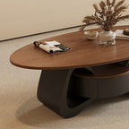 Detail of the coffee table's rounded brown top and open curved dark base.
