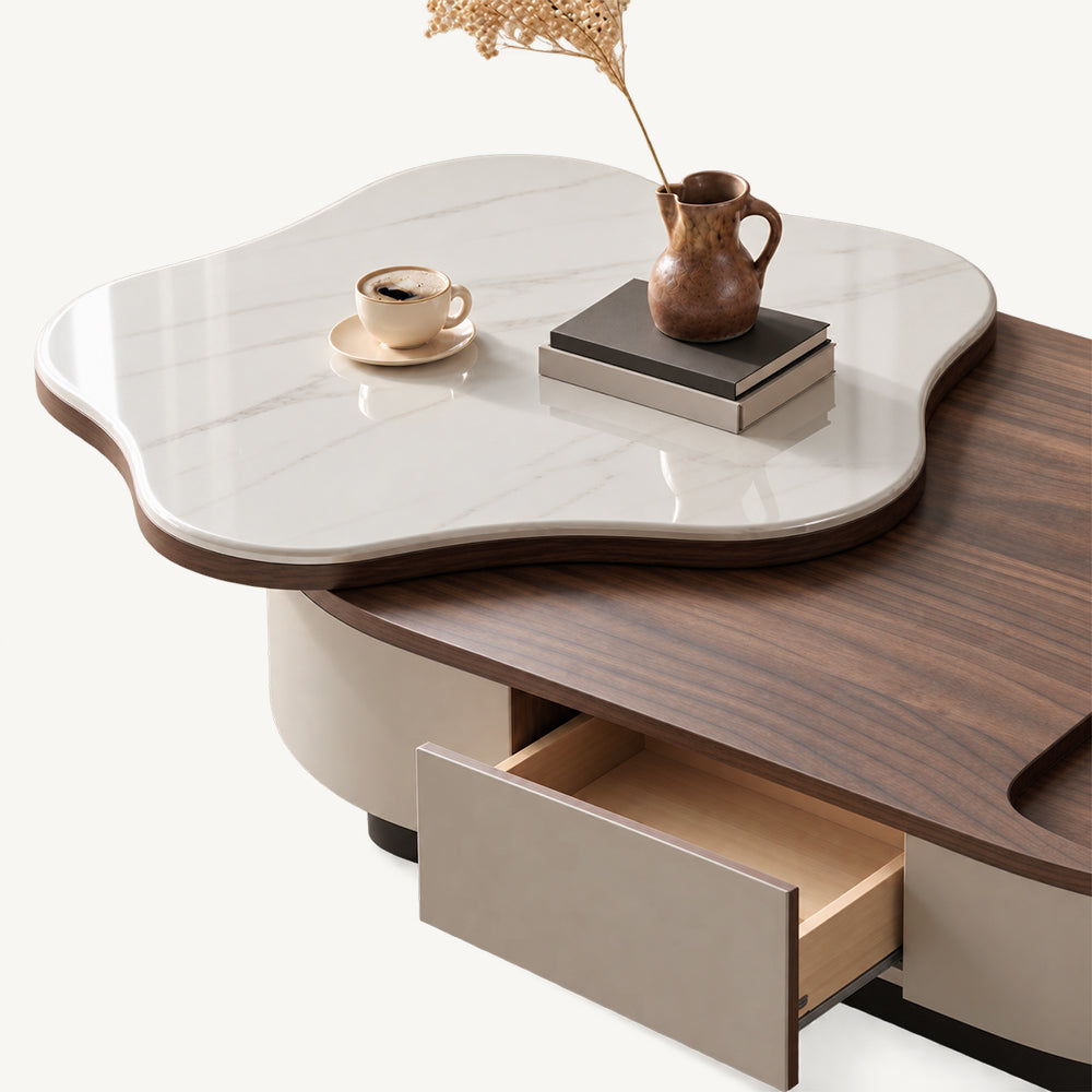 Open drawer beneath the oval coffee table's brown surface and raised white veined tabletop.