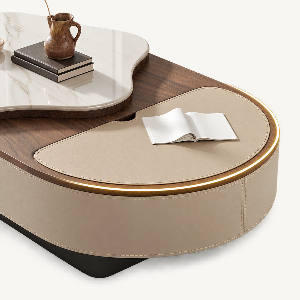 Close-up of the oval coffee table's beige inset surface with its surrounding rim illuminated.