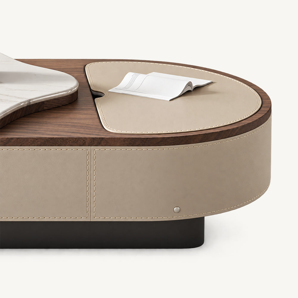 Detail of the coffee table's beige inset top, brown rim and stitched side panel.