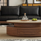 Detail of the oval coffee table's closed brown drawer and recessed tier beneath the tabletop.