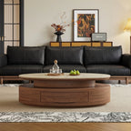 Front view of the oval coffee table showing its closed central drawer and tiered brown base.