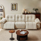 Front view of the cream reclining sofa with both outer footrests extended.