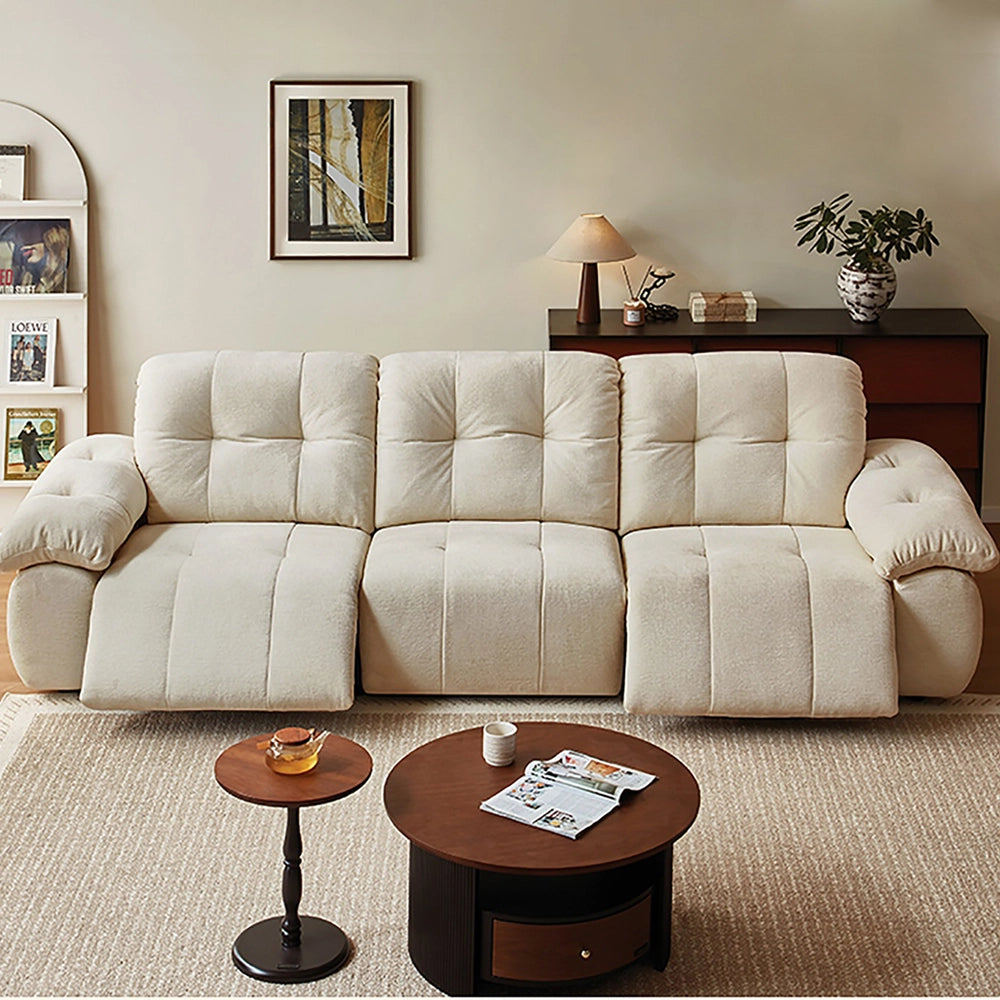 Front view of the cream reclining sofa with both outer footrests extended.