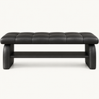 Front view of the black upholstered shoe bench showing its stitched seat, broad supports and empty lower shelf.