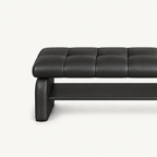 Close-up of the black bench's stitched cushion, left side support and lower storage shelf.