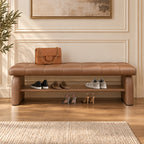 Front view of the brown upholstered shoe bench with shoes on its open lower shelf.