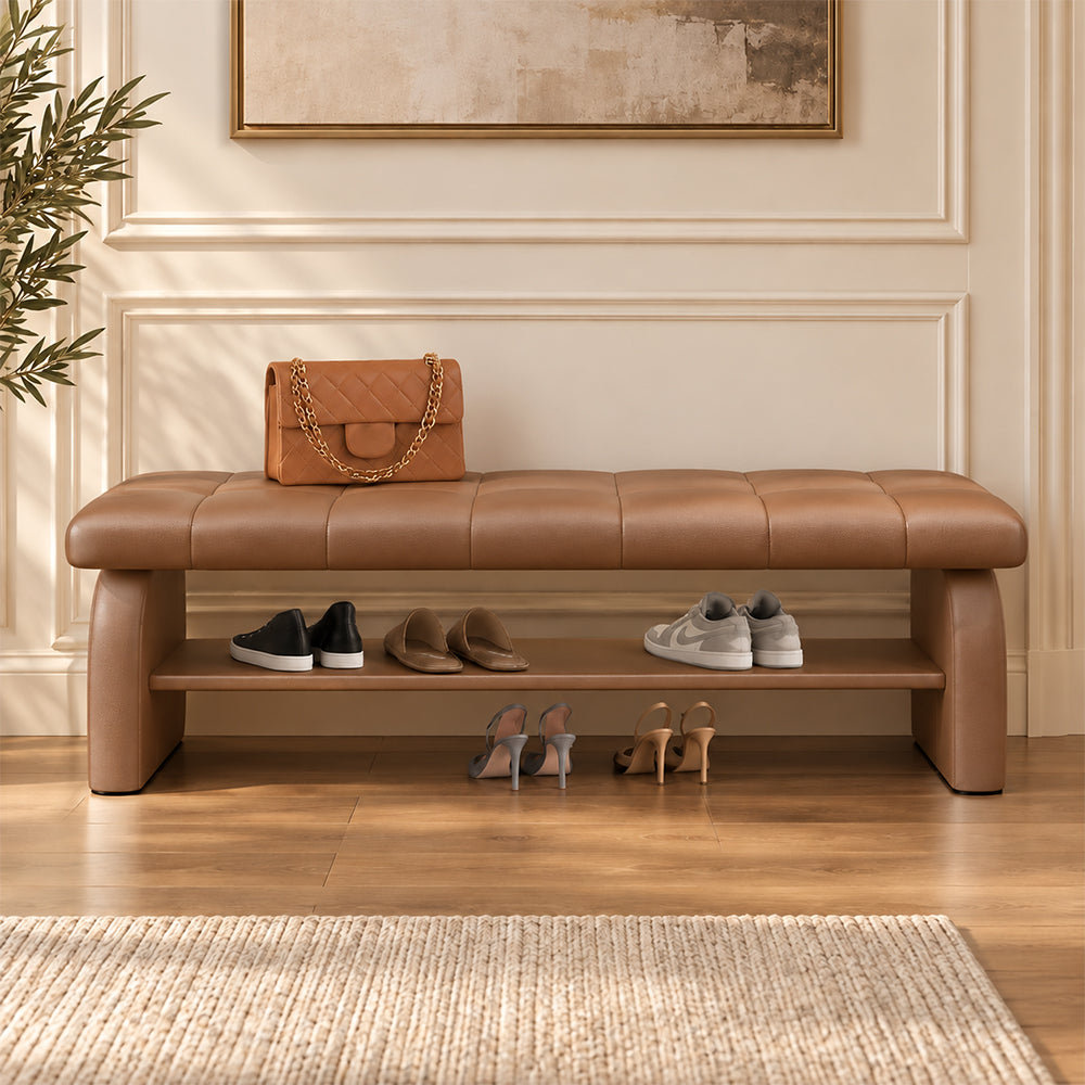 Front view of the brown upholstered shoe bench with shoes on its open lower shelf.
