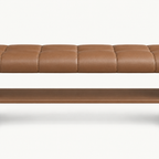 Front detail of the brown bench's stitched seat and long open shelf beneath it.