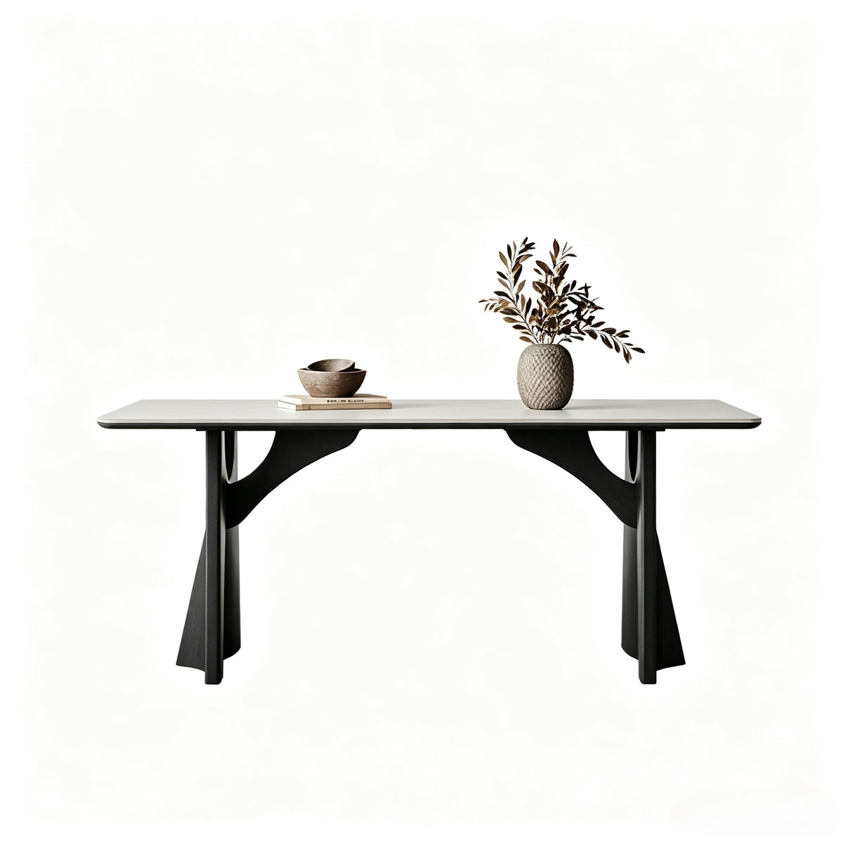 Pale rectangular dining table with black sculptural supports and curved braces on a white background.
