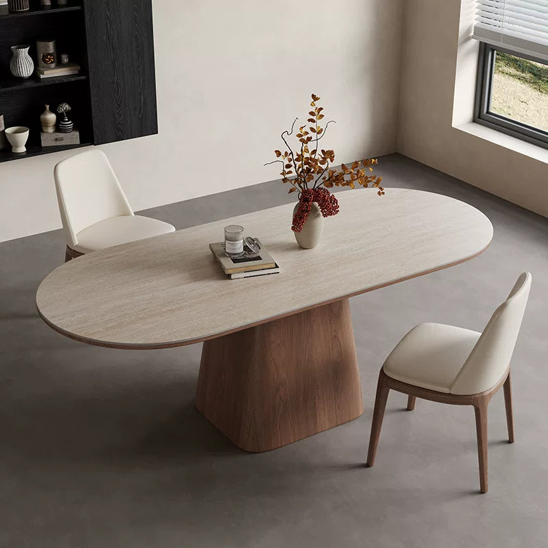 Angled overhead view of the pale oval dining tabletop and central wood-tone pedestal.