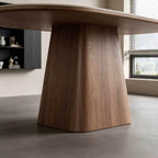 Close-up of the dining table's broad tapered wood-grain pedestal beneath the oval top.